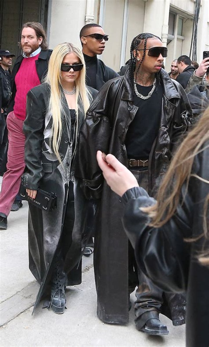 
Who is Tommy Cash? Rapper dressed like bed sits next to Avril Lavigne and Tyga at Paris Fashion Week 